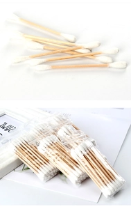 Detailed close-up of double-headed wood cotton swabs in eco-friendly individual packaging