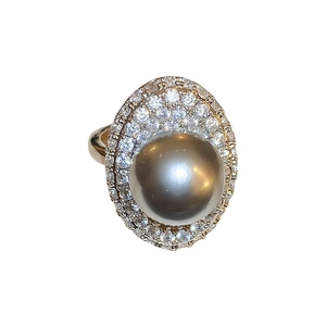 Elegant gold ring featuring a large grey pearl surrounded by sparkling crystal pavé