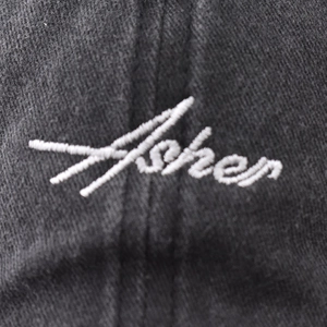 Classic black washed cotton baseball cap with white Asher embroidery in cursive