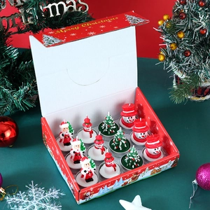Detailed top view of a 12-piece Christmas candle gift set with festive shapes and decor