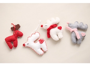 Detailed view of handmade felt reindeer ornaments with embroidery and scarfs