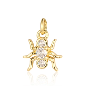 Detailed close-up of a gold spider pendant with three clear sparkling zircon stones
