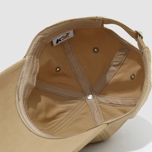Close-up of khaki kids baseball cap interior showing seams and cotton sweatband