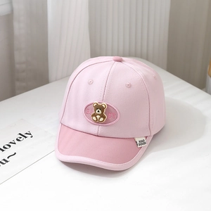 Detail of pink baby baseball cap featuring a 3D bear patch and BABY embroidery