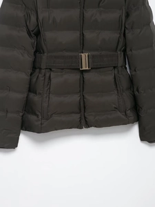 Detail of slim-fit waterproof down jacket featuring a metal waist buckle and quilted texture