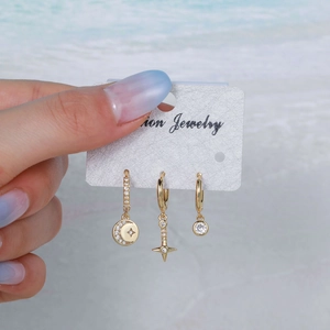Three-piece gold earring set with star and moon charms and micro-inlaid cubic zirconia