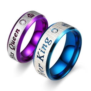 Detailed view of silver brushed couple rings with Her King and His Queen engravings