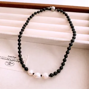 Ethnic glass beads and baroque pearl necklace with magnetic clasp in a jewelry box