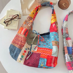 Detailed patchwork tote bag featuring vibrant ethnic patterns and colorful corduroy textures