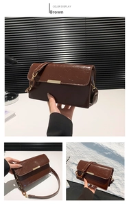 Detail view of brown glossy leather crossbody bag with gold metal buckle and chain strap