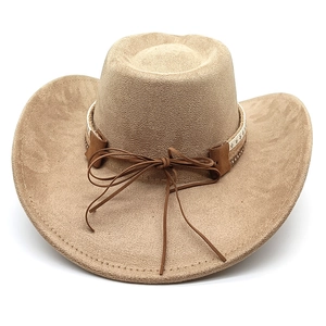 Detail of khaki suede cowboy hat with white star studs and brown leather bow band