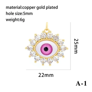 Gold plated copper evil eye pendant with pink resin center and sparkling cubic zirconia stones.