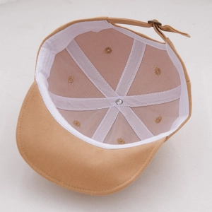 Detail of baby baseball cap interior showing six-panel stitching and adjustable metal buckle