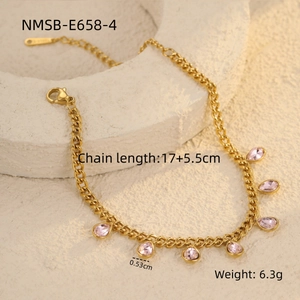 Detailed view of golden chain bracelet with pink teardrop gemstones and lobster clasp