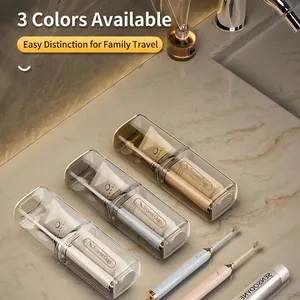 Portable travel toothbrush holder set in three transparent colors on marble vanity
