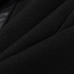 Close-up of premium black wool blend fabric showing fine texture and soft fiber details