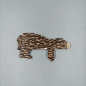 Macro detail of the bear wood grain texture and carved wooden door topper ornament