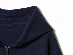 Close-up of navy blue zip-up hoodie featuring double-stitched collar and soft fleece lining