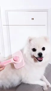 Pink pet grooming brush for long-haired cats and dogs with one-click hair removal button