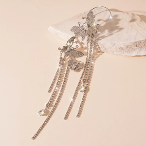 Detailed shot of silver butterfly ear cuff with sparkling zircon tassel fringe on stone