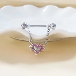 Macro detail of silver barbell nipple ring with pink opal heart pendant and small crystals