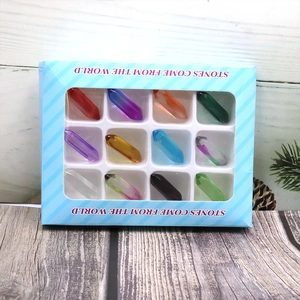 Twelve natural assorted crystal clusters set in a blue striped gift box with clear window