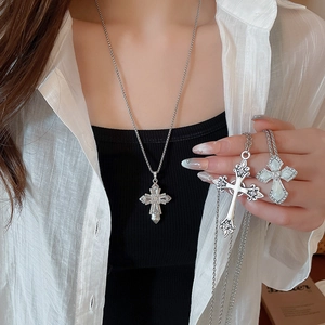 Detailed view of silver cross necklaces with rhinestones and vintage patterns for women
