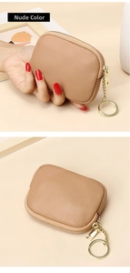 Close-up of nude pebble leather coin purse with gold zipper and keyring detail