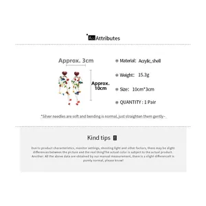 Detailed view of bohemian heart earrings with colorful acrylic shell fringe and silver pins