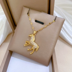 Luxurious gold-plated horse pendant necklace with shimmering crystals on silk display