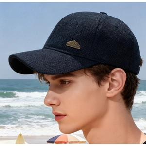 Close-up of winter baseball cap featuring textured blue fabric and a gold mountain badge