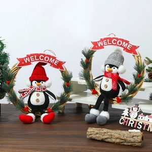 Set of 2 Christmas penguin wreaths with Welcome signs on rustic wooden background