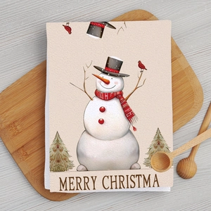 Detail of Christmas microfiber dish towel with snowman print on a wooden board