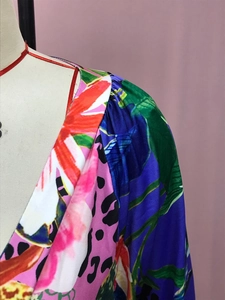 Detalle de tela con estampado de leopardo degradado y hombro plisado elegante