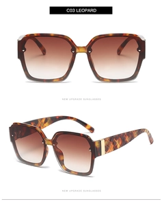 Detail of leopard print sunglasses featuring textured diamond-pattern temples and brown lenses
