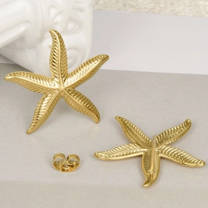 Close-up of matte gold starfish studs with textured stripes and butterfly backings