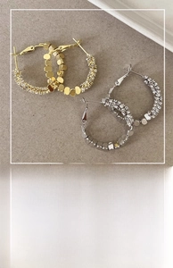 Detailed view of geometric hoop earrings with sparkling beads and a 3cm diameter design