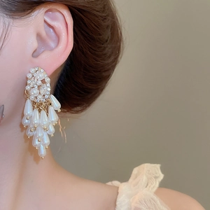 Detail of silver needle pearl tassel earrings with waterdrop pearls and crystals