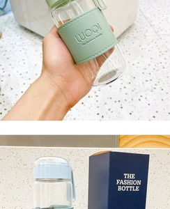 Close-up of glass bottles with green and blue faux leather sleeves and gift packaging