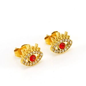 Gold evil eye stud earrings with red zircon and clear crystals on white background