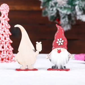 Handcrafted wooden Christmas gnome ornaments with faux fur beards on a festive snowy backdrop.