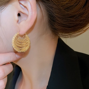 Close-up of 18k gold plated chain hoop earrings with cubic zirconia on female model