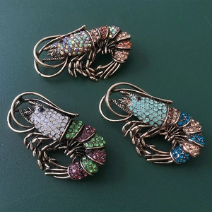 Three vintage lobster brooches in antique gold finish with colorful sparkling rhinestones