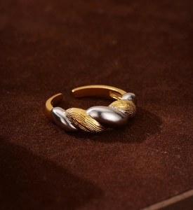Macro shot of two-tone braided S925 silver ring featuring a vintage brushed texture