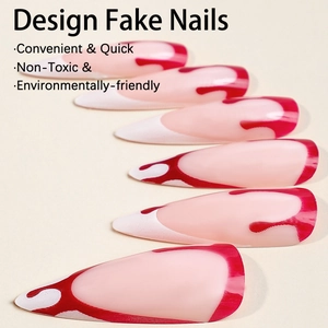 Long stiletto fake nails with red and white flame drip designs on a nude base color