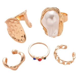Five-piece gold ring set featuring irregular geometric designs with pearls and gems