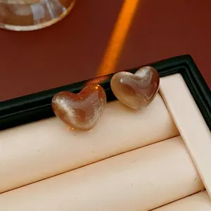 Elegant heart-shaped resin earrings in amber brown with cat-eye silk luster finish