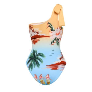 Detail of single-shoulder kids swimsuit with tropical palm print and large orange bow