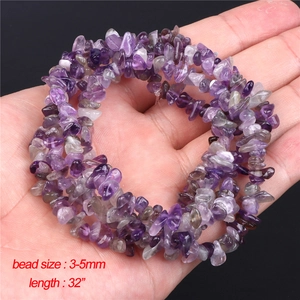 Natural amethyst stone beads 3-5mm on 32-inch strand held by hand over black background