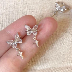 Close-up of zircon butterfly ear clips with starburst dangles for non-pierced ears